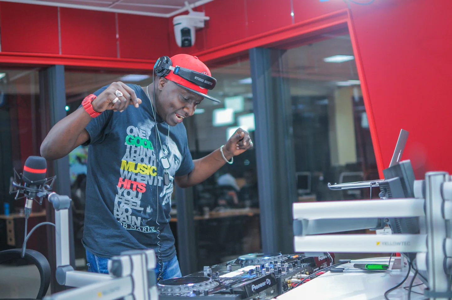 Muzikal Sheriff at DJ decks in a radio studio.