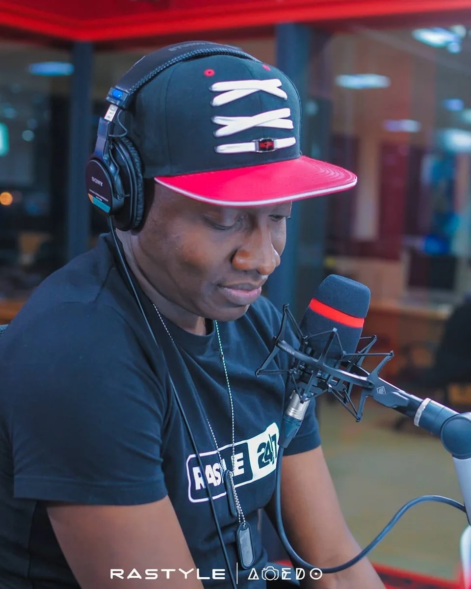 Muzikal Sheriff wearing headphones at a studio microphone.